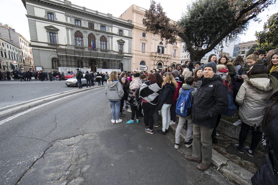 Studenten en leerkrachten staan op straat in Rome, nadat hun school is geëvacueerd.